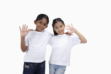 Girls smiling and waving at the camera