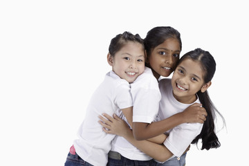 Girls hugging and smiling at the camera