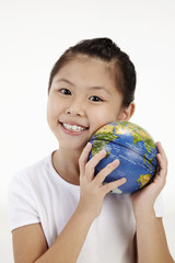 Girl holding globe to her cheek
