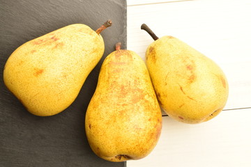 Juicy sweet, organic pears, close-up, on a painted wooden table.