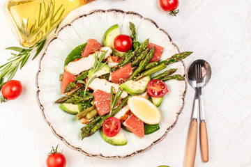 Asparagus salad grapefruit, cherry tomatoes, avocado, chicken fillet, spinach in bowl. ketogenic diet, diet lunch concept. Keto Paleo diet menu