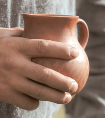 A man with clay jugs in his hand.