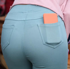 The phone is in the jeans pocket