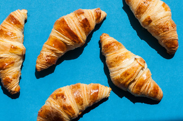 Group of croissants on a blue background.