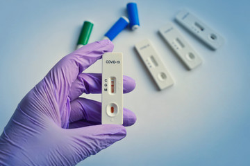 Disposable COVID-19 test kit for rapid detection of antibodies in the finger prick blood sample. Positive test result after recovery from infection. 