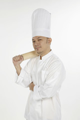 Asian chef holding a rolling pin