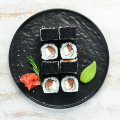 Sushi rolls -Fila Black with black caviar, salmon and cheese. Top view. Free space for your text.