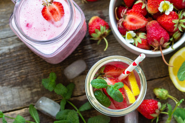 Healthy dieting concept. Lemonade with fresh strawberries and Strawberry fruit Yogurt smoothie or milk shake on a rustic wooden table. Top view flat lay background. Copy space.