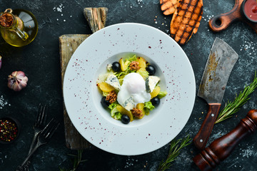 Salad with vegetables, blue cheese, olives and nuts. Vegetable salad. Top view. Free copy space.