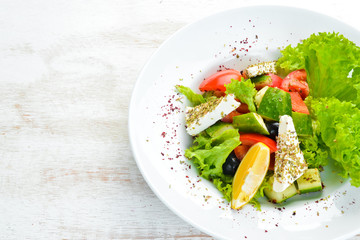 Salad with vegetables and feta cheese. Vegetable salad. Top view. Free copy space.