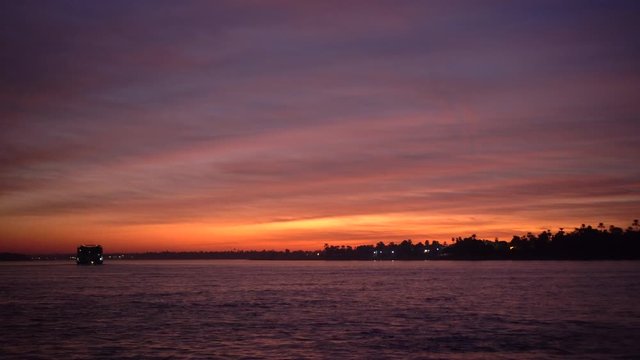 Beautiful sunset in the middle of Nile river crusing famous tourist activity in Egypt