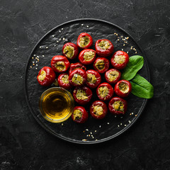 Pickled peppers stuffed with capers. Italian traditional dish. Top view. Free space for your text.