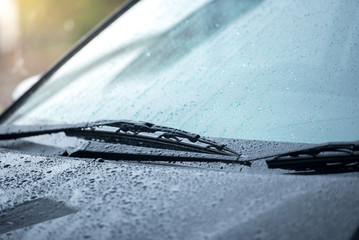 Cars parked in the rain in the rainy season and have a wiper system to clear the windshield from the windshield., Close-up car rain wipers, rainy weather and vehicles concept - obrazy, fototapety, plakaty