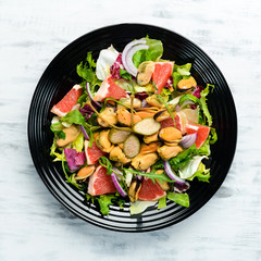 Salad with mussels, grapefruit and vegetables. Top view. Free space for your text.