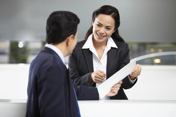 Sales representative interacting with a customer at the counter