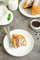 Traditional Italian cake Zuccotto on a white plate decorated with powdered sugar and berries on top. Vertical orientation. Copy space, selective focus.