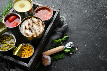 Food stocks. Food in tin cans. Vegetables, fruits, fish, meat and legumes are marinated in jars.