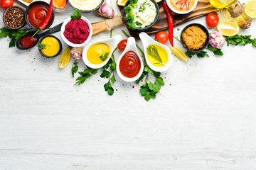 Colored sauces in bowls on a white background. Top view.