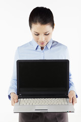Mid adult businesswoman holding laptop