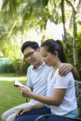 Man and woman reading in the park