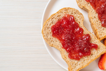 whole wheat bread with strawberry jam and fresh strawberry