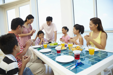 Group of people celebrating boy's birthday