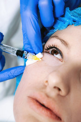 doctor cosmetologist makes Rejuvenating Biorevitalization facial injections procedure on female skin in beauty salon