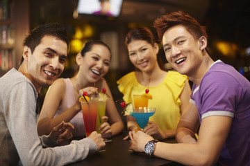 Fototapeta premium Four young people having a gathering