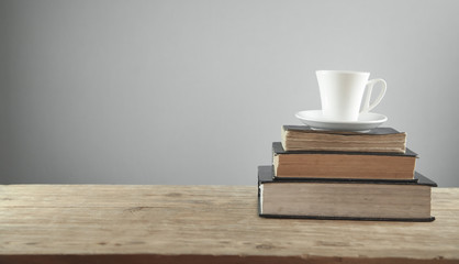 Coffee and books on the wooden table.