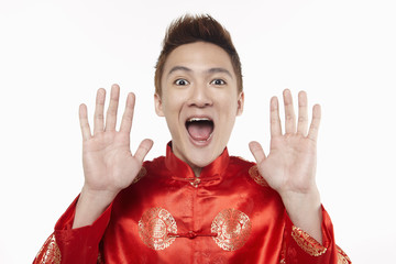 Excited man in traditional clothing shouting with mouth and hands opened
