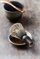 Bamboo tea whisk on rustic stone background. Close up.