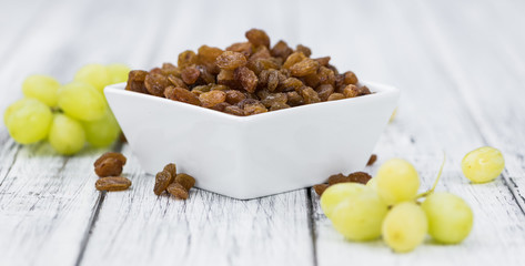 Portion of healthy Raisins (selective focus; close-up shot)