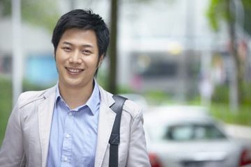 Businessman standing outdoors and smiling