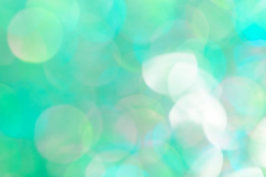 Bokeh pattern on a bluish green background