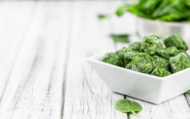 Frozen spinach cubes (close up; selective focus)