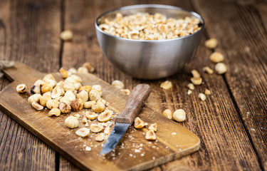 Portion of freshly chopped Hazelnuts (close up; selective focus)