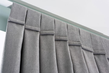 Closeup view velcro loops of curtain in thin and thick vertical folds made of dense fabric.Textured materials and textiles abstract backgrounds.