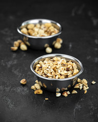 Portion of freshly chopped Hazelnuts (close up; selective focus)