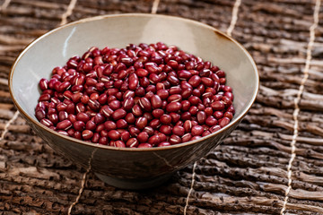 A Bowl Of Small Red Beans On The Branch Table Mat