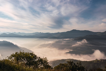 View from above of a valley covered by mist. Landscape of high mountains in a sunshine at the north...