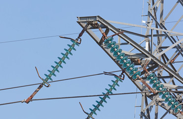 High-voltage electricity pylon against blue sky