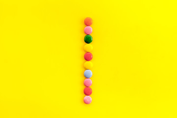 Letter I - alphabet made with sweets on yellow from above