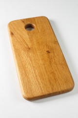 Brown board for slicing food on a white background