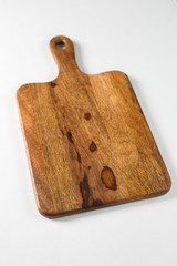 Brown board for slicing food on a white background