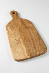 Brown board for slicing food on a white background