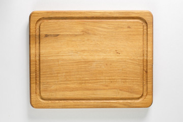 Brown board for slicing food on a white background