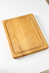 Brown board for slicing food on a white background