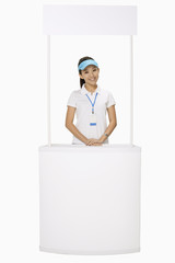 Woman standing behind a booth