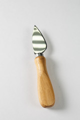 Cheese knife with a wooden handle on a white background