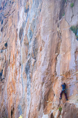 A strong girl climbs a rock, Rock climbing in Turkey.